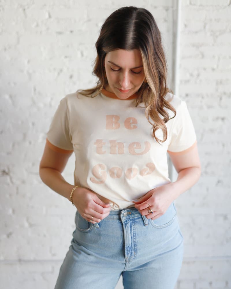 Front of a model wearing a size Large Be The Good Retro Ringer T-Shirt in Ivory by Polished Prints. | dia_product_style_image_id:239708